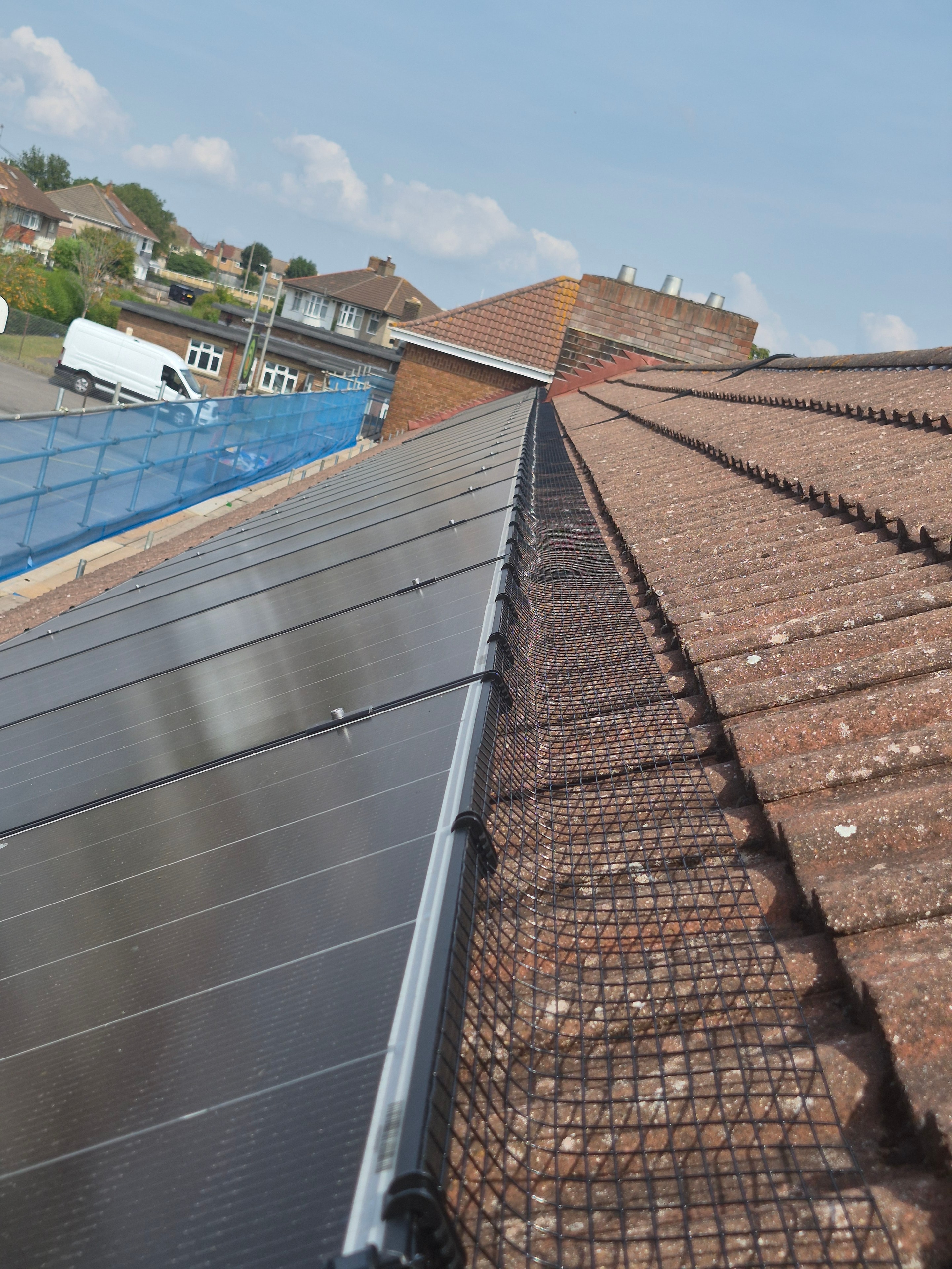 Professional bird-proofing mesh installation on solar panels